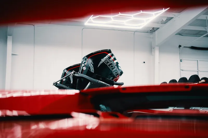 Slide: The Image of Red Statement 360 CAT boat in a modern garage, showcasing sleek design and advanced features. - 22