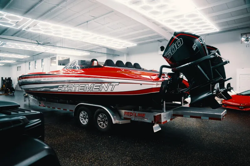 Slide: The Image of Red 2025 Statement 360 CAT powerboat on trailer in a well-lit garage. - 4