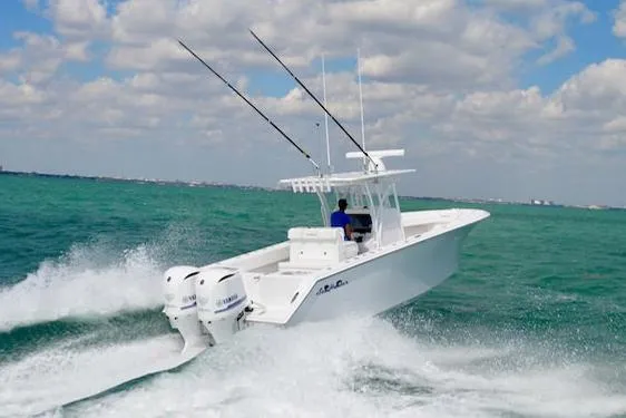 Slide: The Image of Manufacturer Provided Image: 2025 SeaHunter 31 Tournament boat speeding on turquoise ocean waters. - 2
