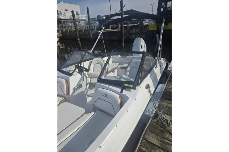 Slide: The Image of 2025 Stingray 191 DC boat docked, featuring sleek design and comfortable seating. - 10
