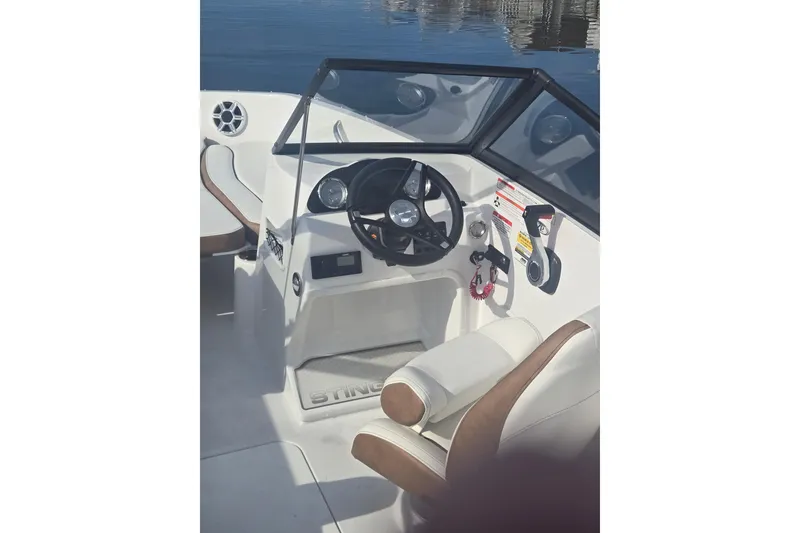 Slide: The Image of 2025 Stingray 191 DC boat cockpit with steering wheel and controls. - 12