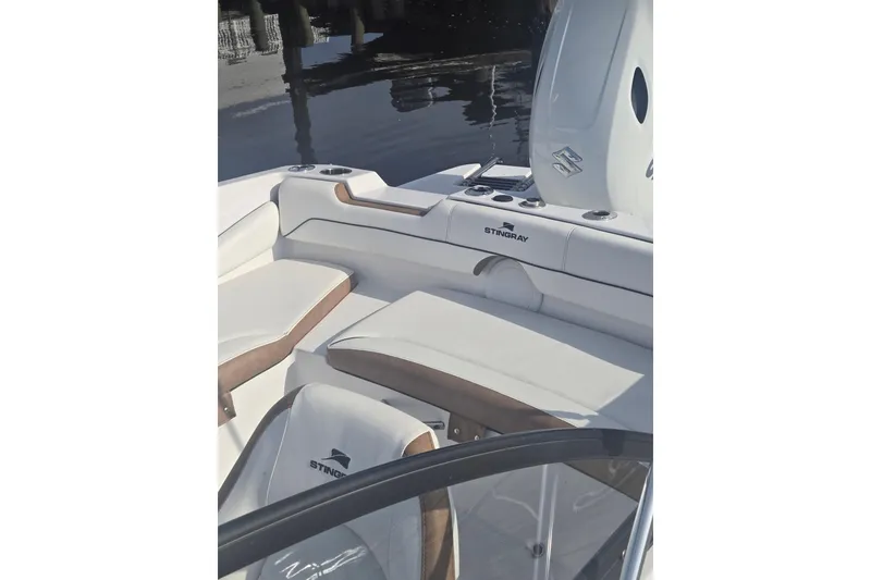 Slide: The Image of 2025 Stingray 191 DC boat interior with white seating and sleek design. - 7
