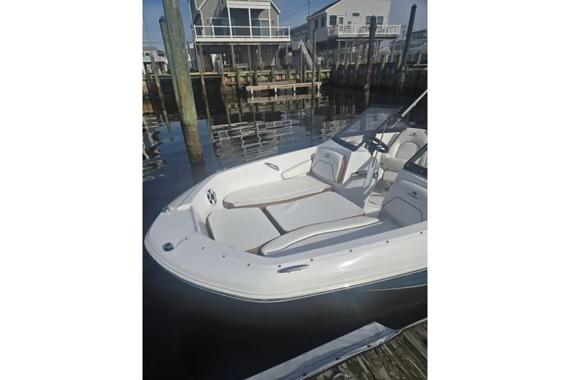 Slide: The Image of 2025 Stingray 191 DC boat docked, showcasing sleek design and comfortable seating. - 9