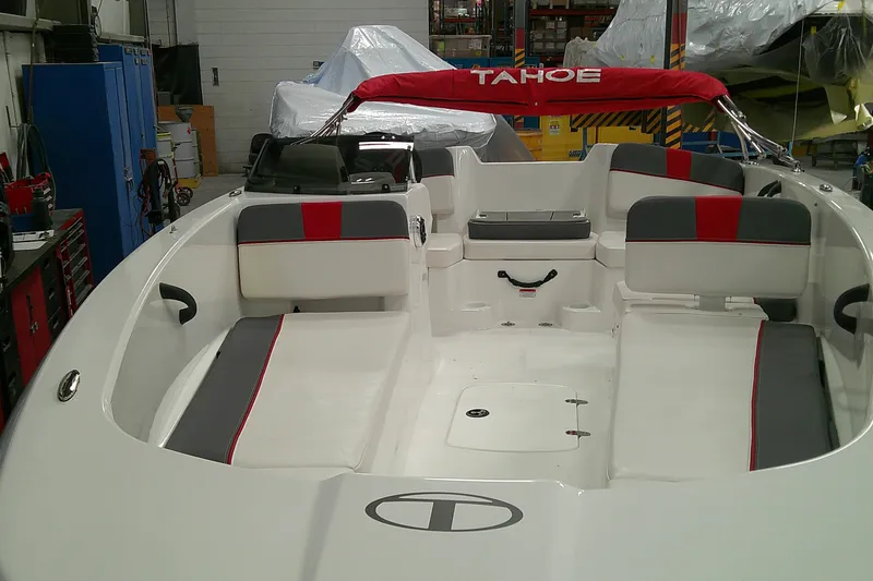 Slide: The Image of 2024 Tahoe T18 boat interior with red and gray seating in a workshop setting. - 2