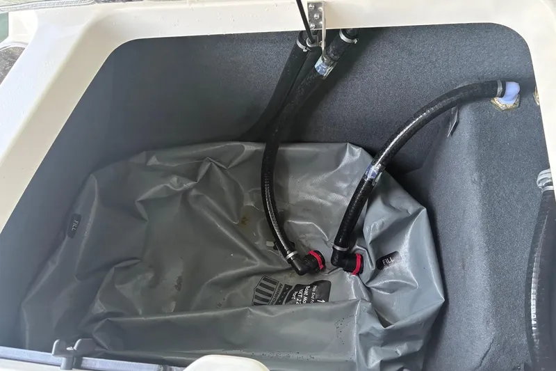Slide: The Image of 2018 MasterCraft NXT22 ballast system with hoses and fill bag. - 13