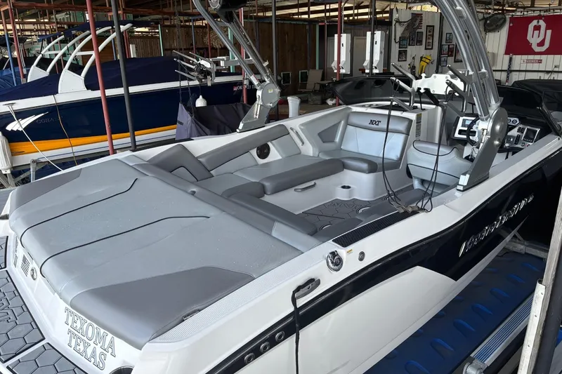 Slide: The Image of 2018 MasterCraft NXT22 boat with gray seating, docked in Texoma, Texas. - 2