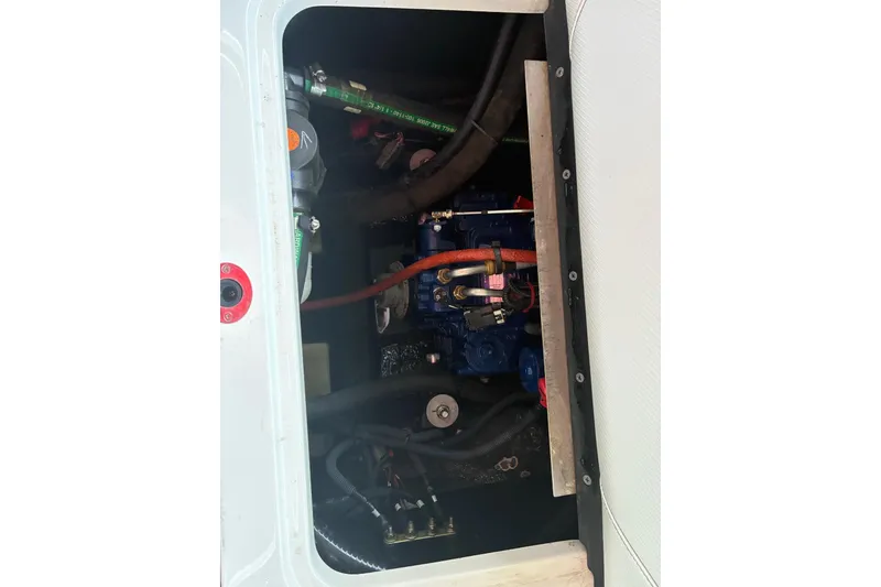 Slide: The Image of Engine compartment of a 2018 MasterCraft NXT22 boat, showcasing internal components. - 20