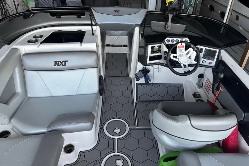 Slide: The Image of 2018 MasterCraft NXT22 boat interior with modern dashboard and seating. - 8