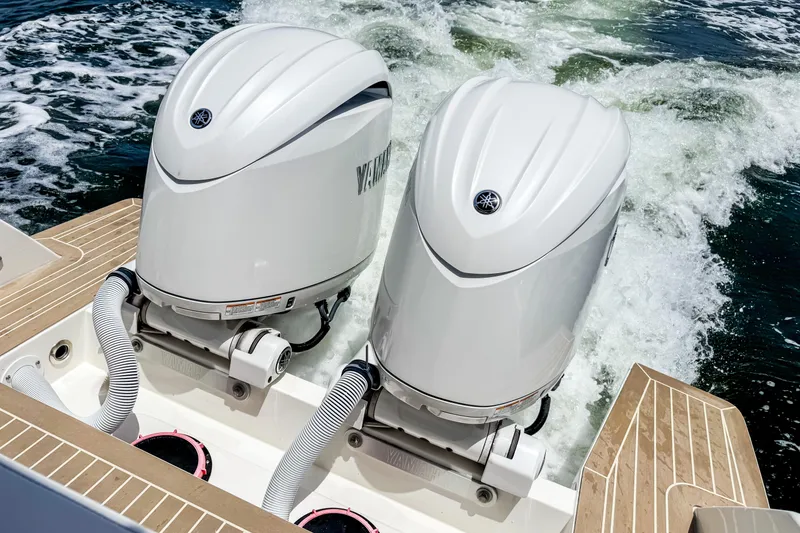 Slide: The Image of Two powerful outboard engines propel the boat through splashing water, surrounded by sleek deck design. - 5
