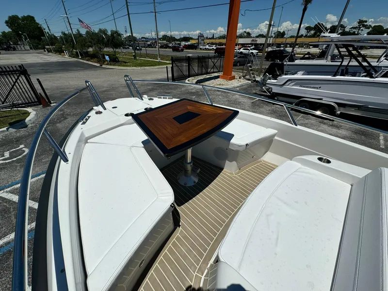 Slide: The Image of 2024 Windy SR28 CC boat with white seating and wooden table in the bow. - 5