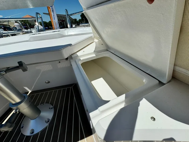 Slide: The Image of 2024 Windy SR28 CC boat storage compartment with open lid. - 10