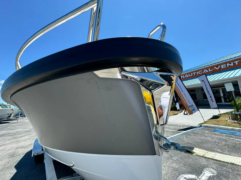 Slide: The Image of 2024 Windy SR28 CC boat bow at a nautical dealership. - 2