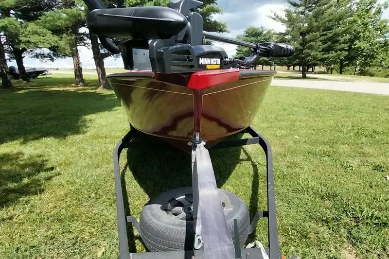 Slide: The Image of 2025 Tracker Super Guide V-16 SC boat on trailer, parked on grassy area. - 10