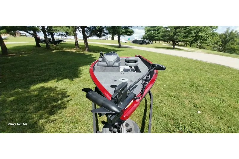 Slide: The Image of 2025 Tracker Super Guide V-16 SC boat on grassy area, surrounded by trees. - 11