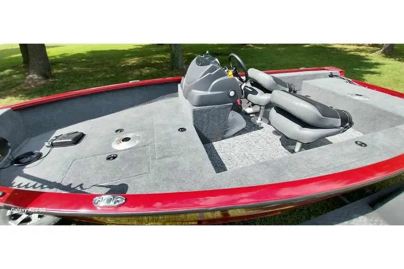 Slide: The Image of 2025 Tracker Super Guide V-16 SC boat interior with red trim and dual seats. - 15
