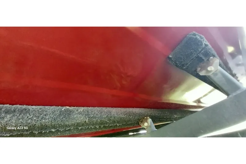 Slide: The Image of Red Tracker Super Guide V-16 SC boat hull, 2025 model, on a trailer. - 19