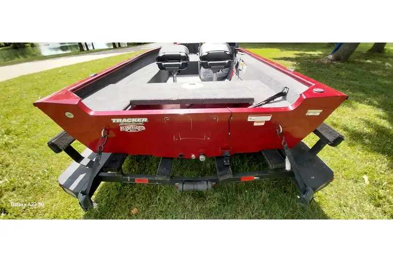 Slide: The Image of 2025 Tracker Super Guide V-16 SC boat on trailer, parked on grass. - 22