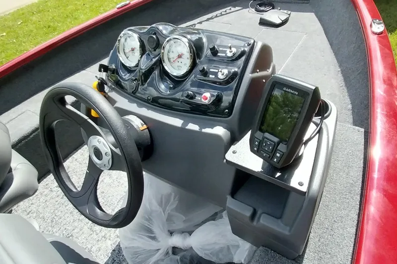 Slide: The Image of 2025 Tracker Super Guide V-16 SC boat dashboard with steering wheel and Garmin device. - 4