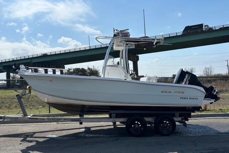 Slide: The Image of 2008 Seapro 206CC boat on trailer under bridge, clear sky background. - 11