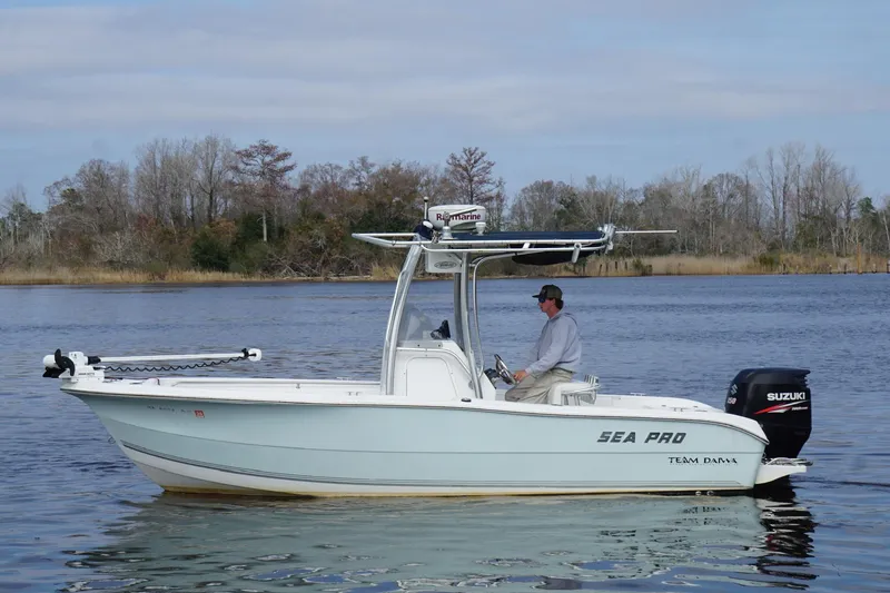 Slide: The Image of 2008 Seapro 206CC boat on calm water with a Suzuki outboard motor. - 13