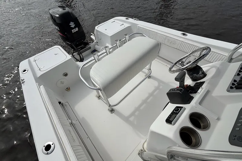 Slide: The Image of 2008 Seapro 206CC boat interior with Suzuki 150 engine, white seating, and steering console. - 4