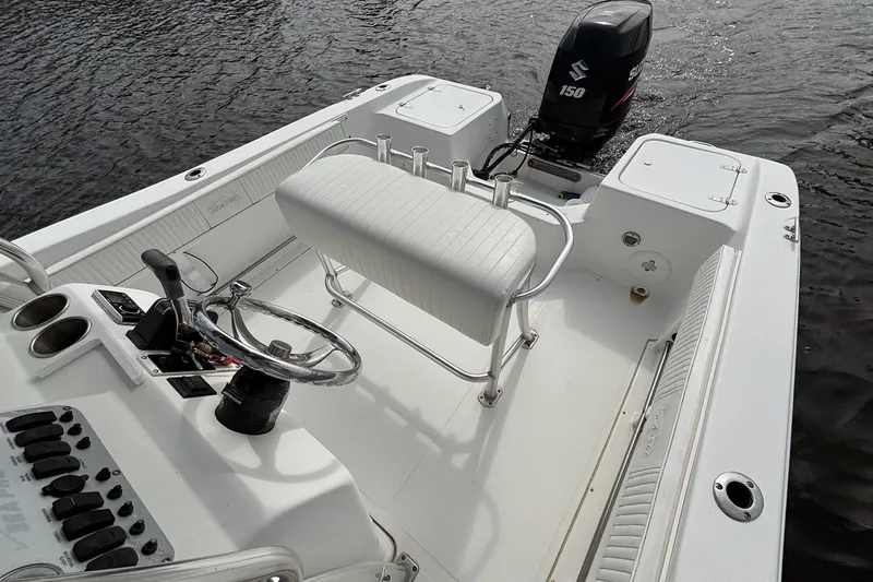 Slide: The Image of 2008 Seapro 206CC boat interior with steering wheel and Suzuki 150 outboard motor. - 5