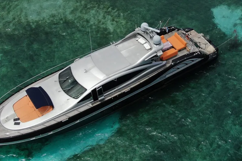 The Image of Aerial view of 2005 Mangusta 92 yacht on clear turquoise water. - 1