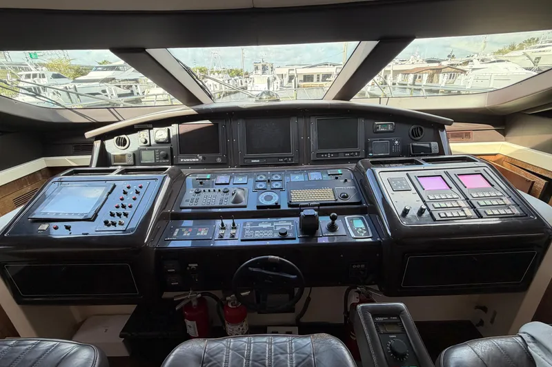 Slide: The Image of Cockpit of a 2005 Mangusta 92 yacht with advanced navigation controls and displays. - 11