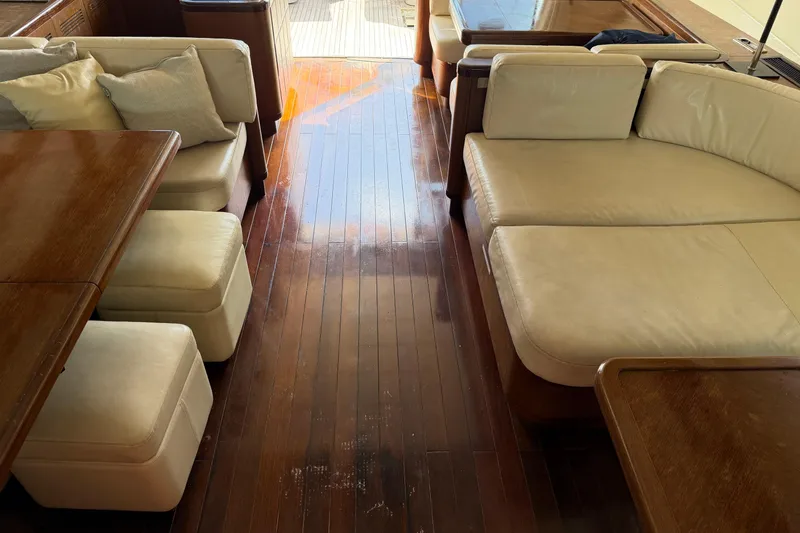 Slide: The Image of Luxurious interior of a 2005 Mangusta 92 yacht with elegant wood flooring and plush seating. - 14