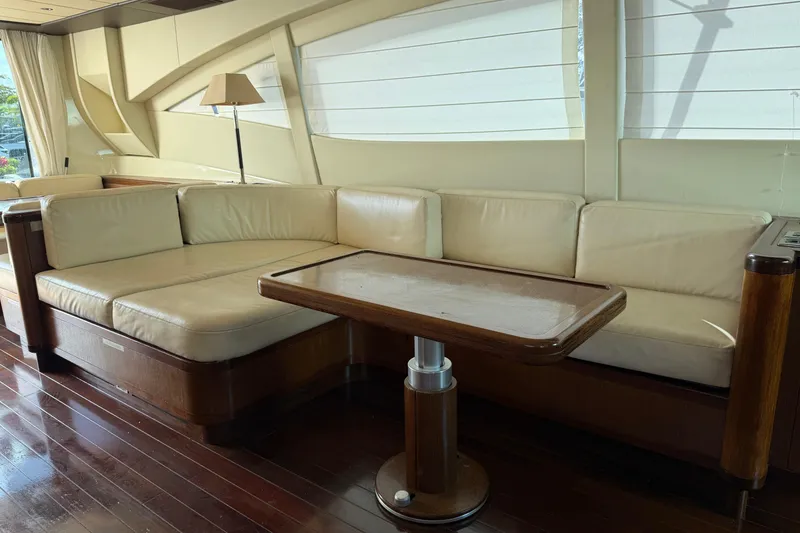 Slide: The Image of Luxurious interior of 2005 Mangusta 92 yacht with cream leather seating and wooden table. - 15