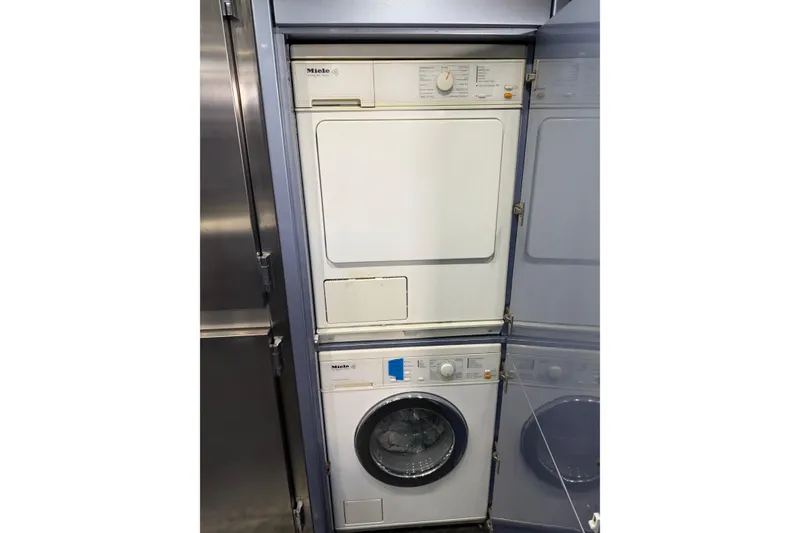 Slide: The Image of Stacked Miele washer and dryer in a 2005 Mangusta 92 yacht. - 19