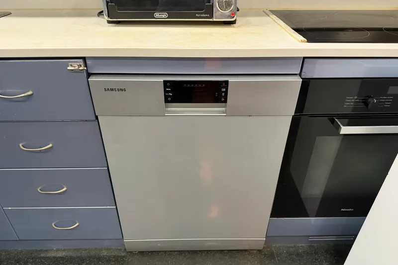Slide: The Image of Modern kitchen with Samsung dishwasher, sleek cabinets, and countertop appliances. - 21