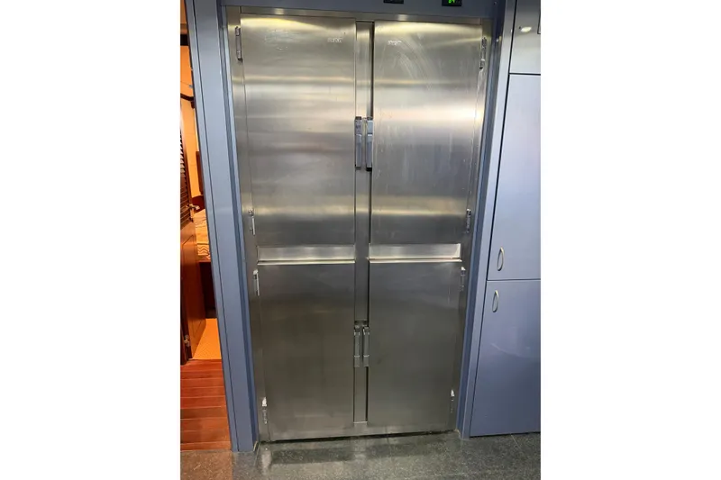 Slide: The Image of Stainless steel refrigerator on a 2005 Mangusta 92 yacht interior. - 22