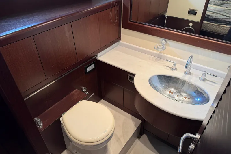 Slide: The Image of Luxurious bathroom in 2005 Mangusta 92 yacht with wooden cabinetry and modern fixtures. - 24