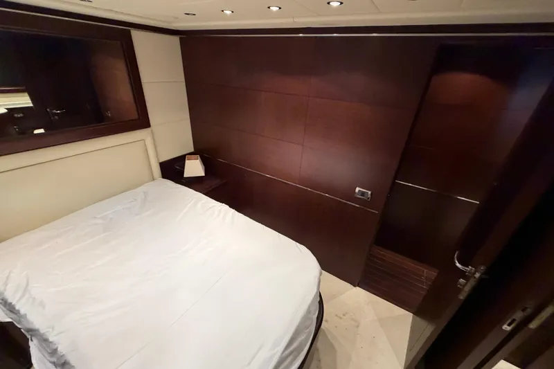 Slide: The Image of Luxurious bedroom interior of 2005 Mangusta 92 yacht with elegant wood paneling. - 27