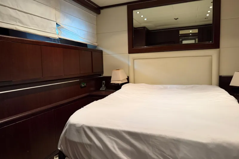 Slide: The Image of Luxurious bedroom interior of 2005 Mangusta 92 yacht with elegant wood paneling. - 28