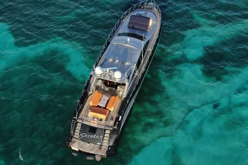 Slide: The Image of Aerial view of 2005 Mangusta 92 yacht on clear turquoise water. - 3
