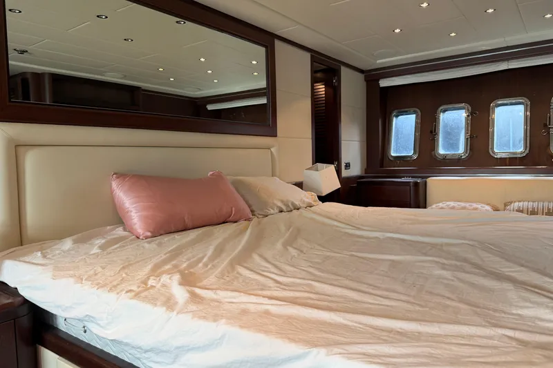 Slide: The Image of Luxurious bedroom interior of 2005 Mangusta 92 yacht with elegant bedding and porthole windows. - 32