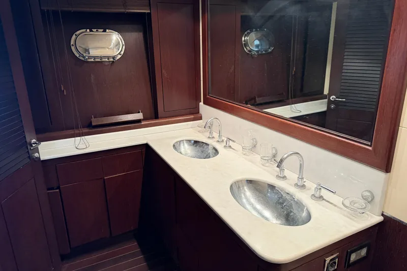 Slide: The Image of Luxurious bathroom interior of 2005 Mangusta 92 yacht with dual sinks and wooden cabinetry. - 34