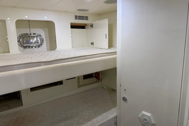 Slide: The Image of Interior of 2005 Mangusta 92 yacht featuring bunk beds and a porthole window. - 38