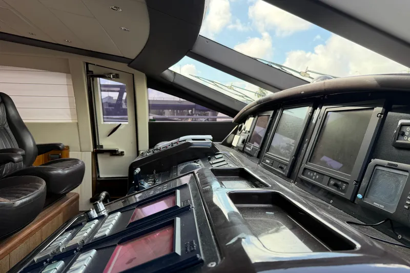 Slide: The Image of Cockpit of 2005 Mangusta 92 yacht with modern navigation equipment and leather seating. - 42