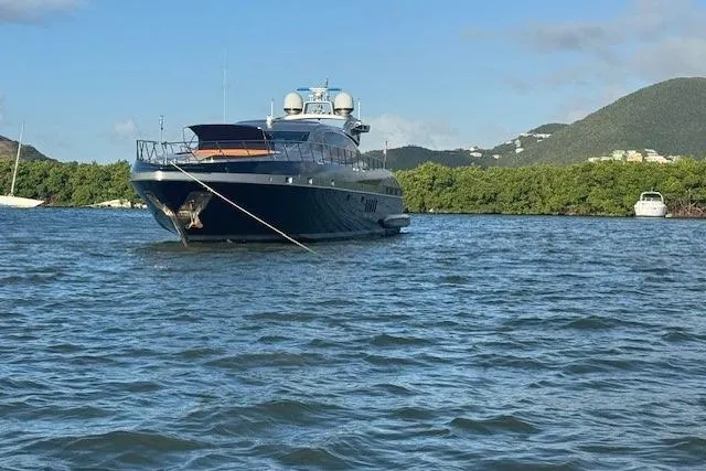 Slide: The Image of Luxury 2005 Mangusta 92 yacht anchored in scenic coastal waters. - 7