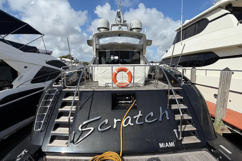 Slide: The Image of Luxury 2005 Mangusta 92 yacht docked in Miami marina under a cloudy sky. - 8