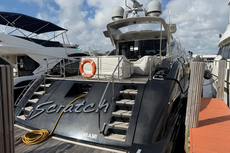 Slide: The Image of Luxury 2005 Mangusta 92 yacht docked in Miami marina, featuring sleek design and modern amenities. - 9