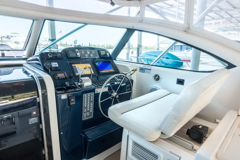 Slide: The Image of 2007 Tiara Yachts 3800 Open helm with navigation equipment and white seating. - 12