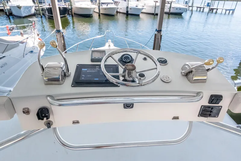 Slide: The Image of Helm of 2007 Tiara Yachts 3800 Open with steering wheel and controls, docked at marina. - 13