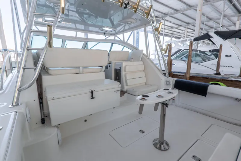 Slide: The Image of 2007 Tiara Yachts 3800 Open interior with white seating and fishing rod holders. - 14