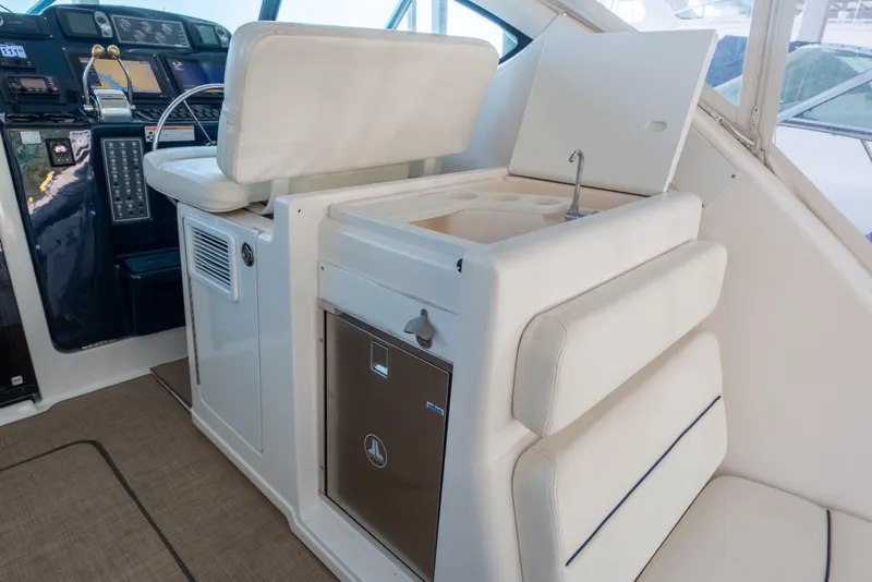 Slide: The Image of 2007 Tiara Yachts 3800 Open interior with helm, seating, and compact kitchenette. - 17