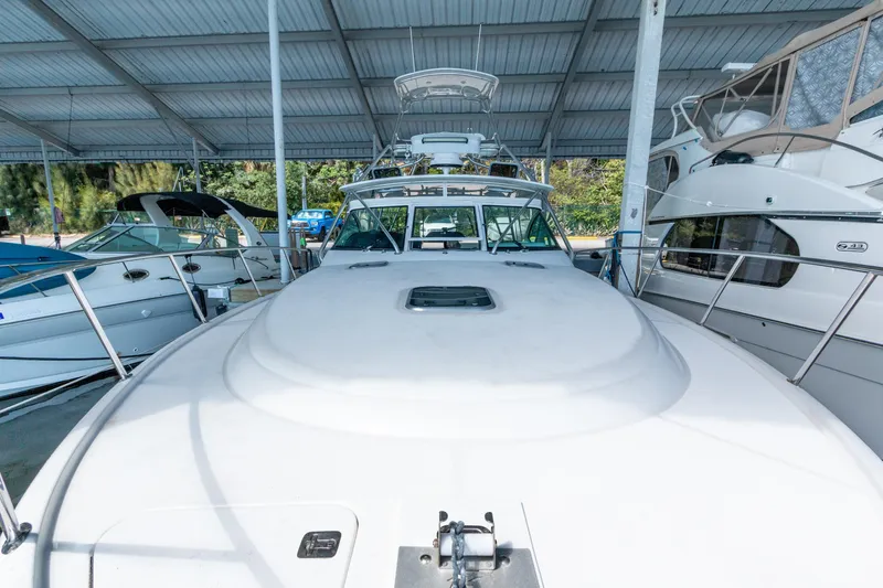 Slide: The Image of 2007 Tiara Yachts 3800 Open docked under a covered marina. - 22