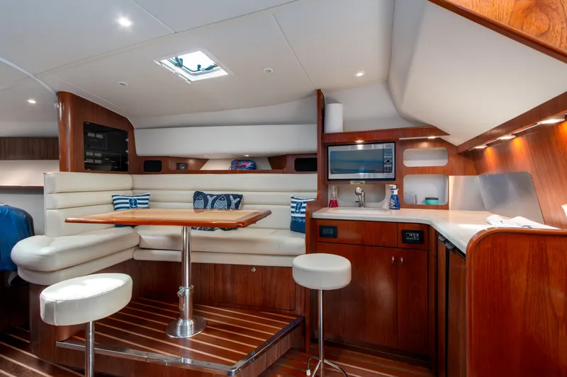 Slide: The Image of Luxurious interior of 2007 Tiara Yachts 3800 Open with seating, table, and kitchenette. - 26
